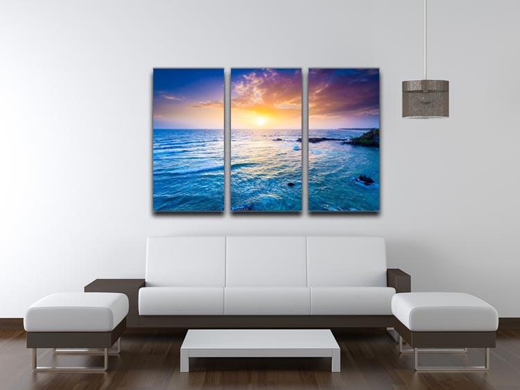 A stunning 3-panel canvas print depicting a vibrant sunset over the Indian Ocean, showcasing rich colors and serene waves.