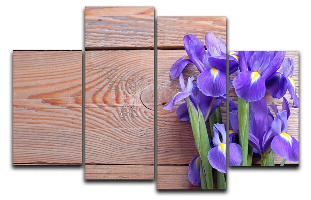 A vibrant iris flower artwork displayed on a rustic wooden background, divided into four equal canvas panels.