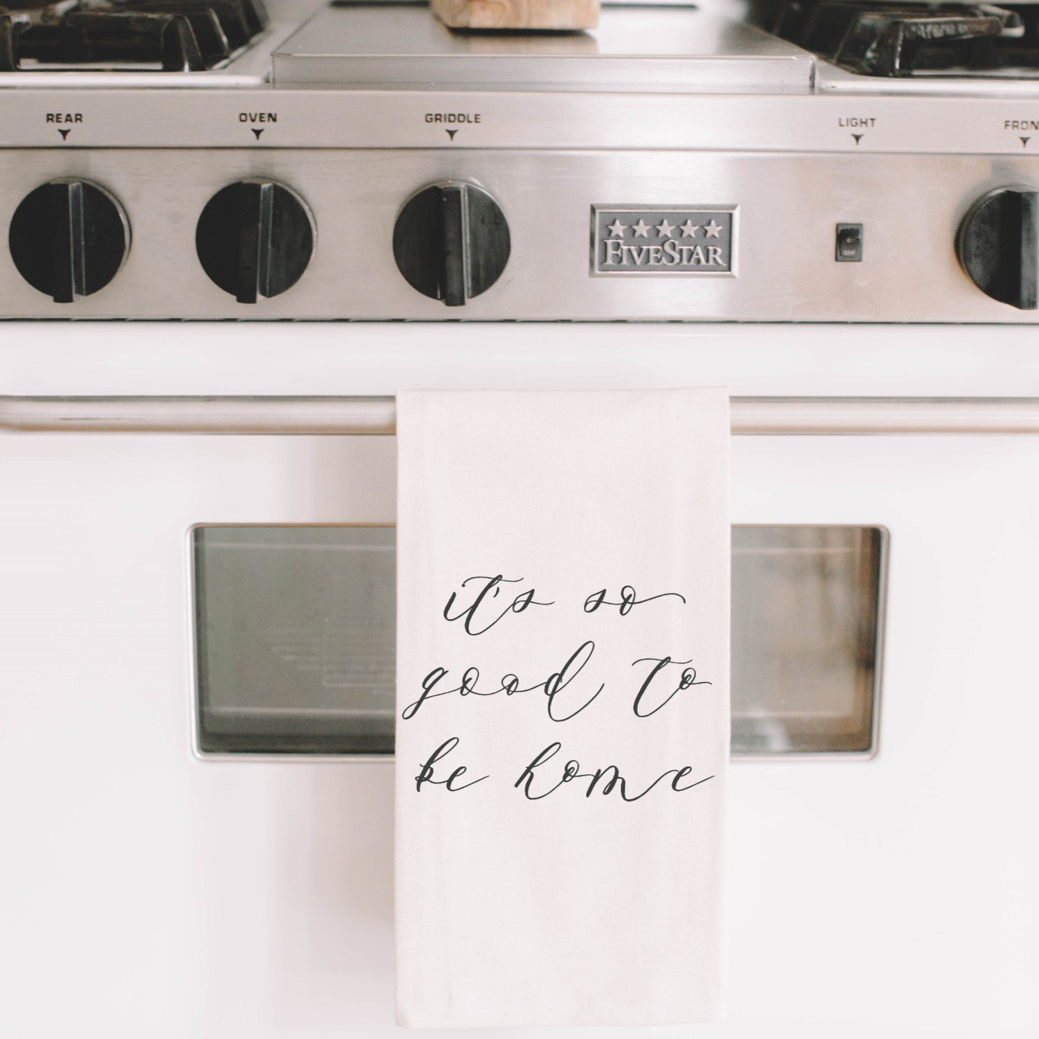 It's So Good To Be Home Kitchen Towel featuring unique calligraphy design by Alyssa Thiel, made from 100% organic cotton in white and natural colors.