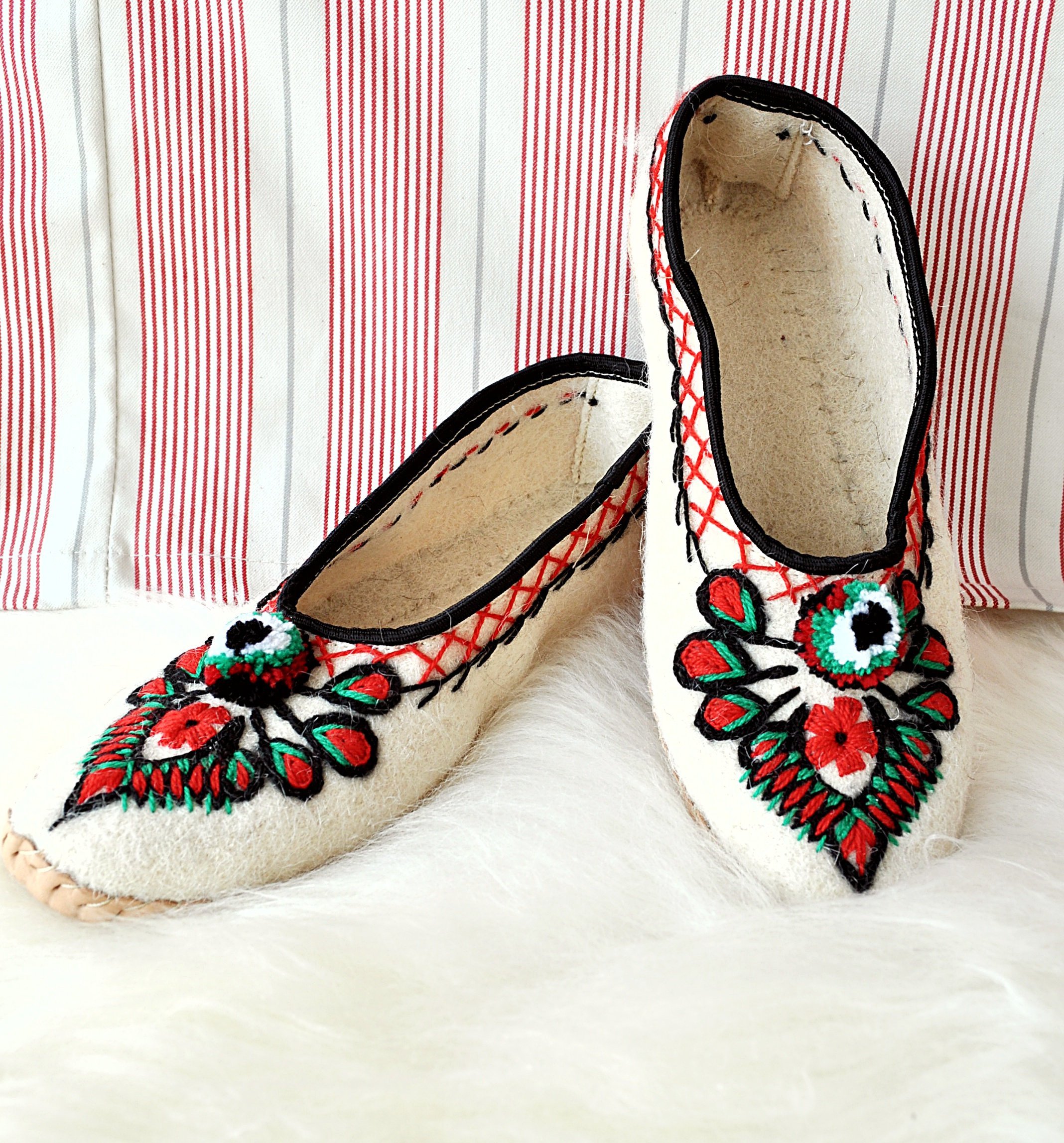 Ivory felt and real leather folk slippers, showcasing their elegant design and handmade craftsmanship.
