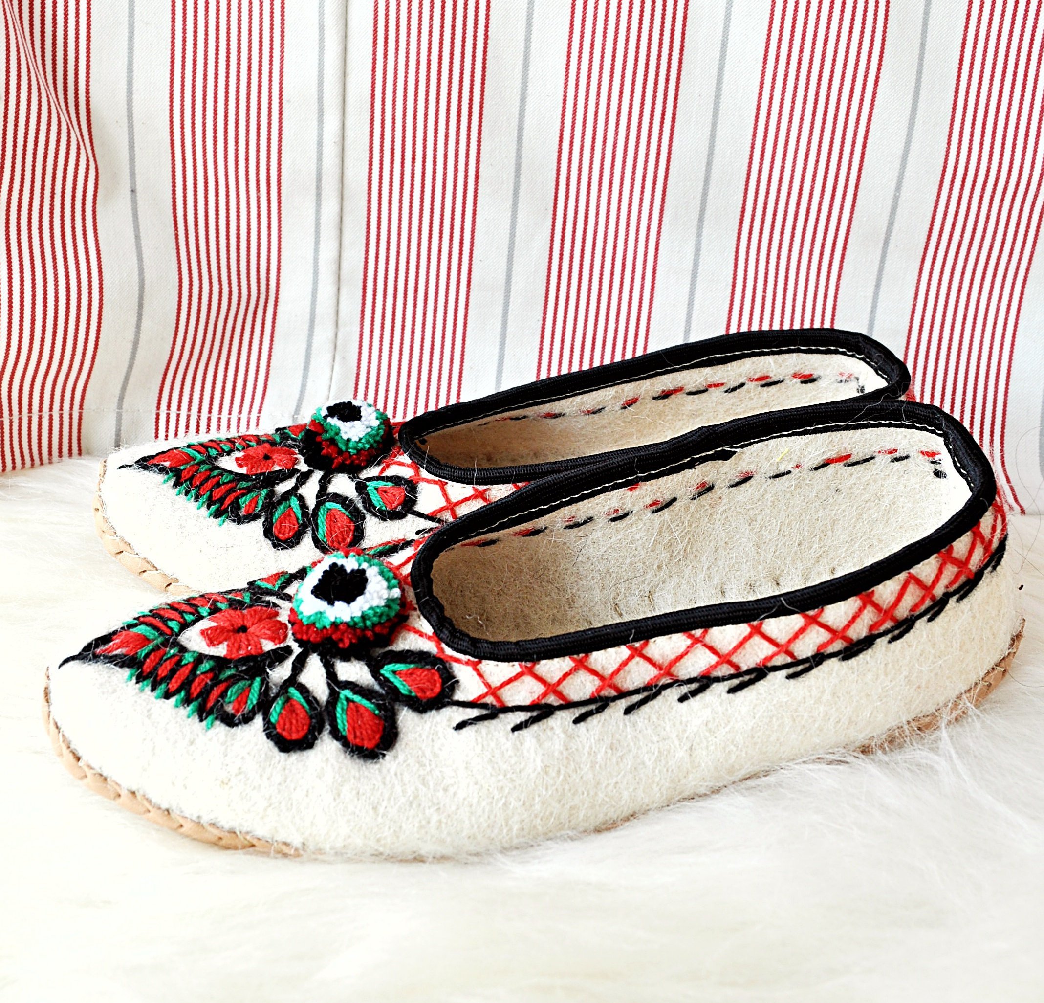 Ivory felt and real leather folk slippers, showcasing their elegant design and handmade craftsmanship.
