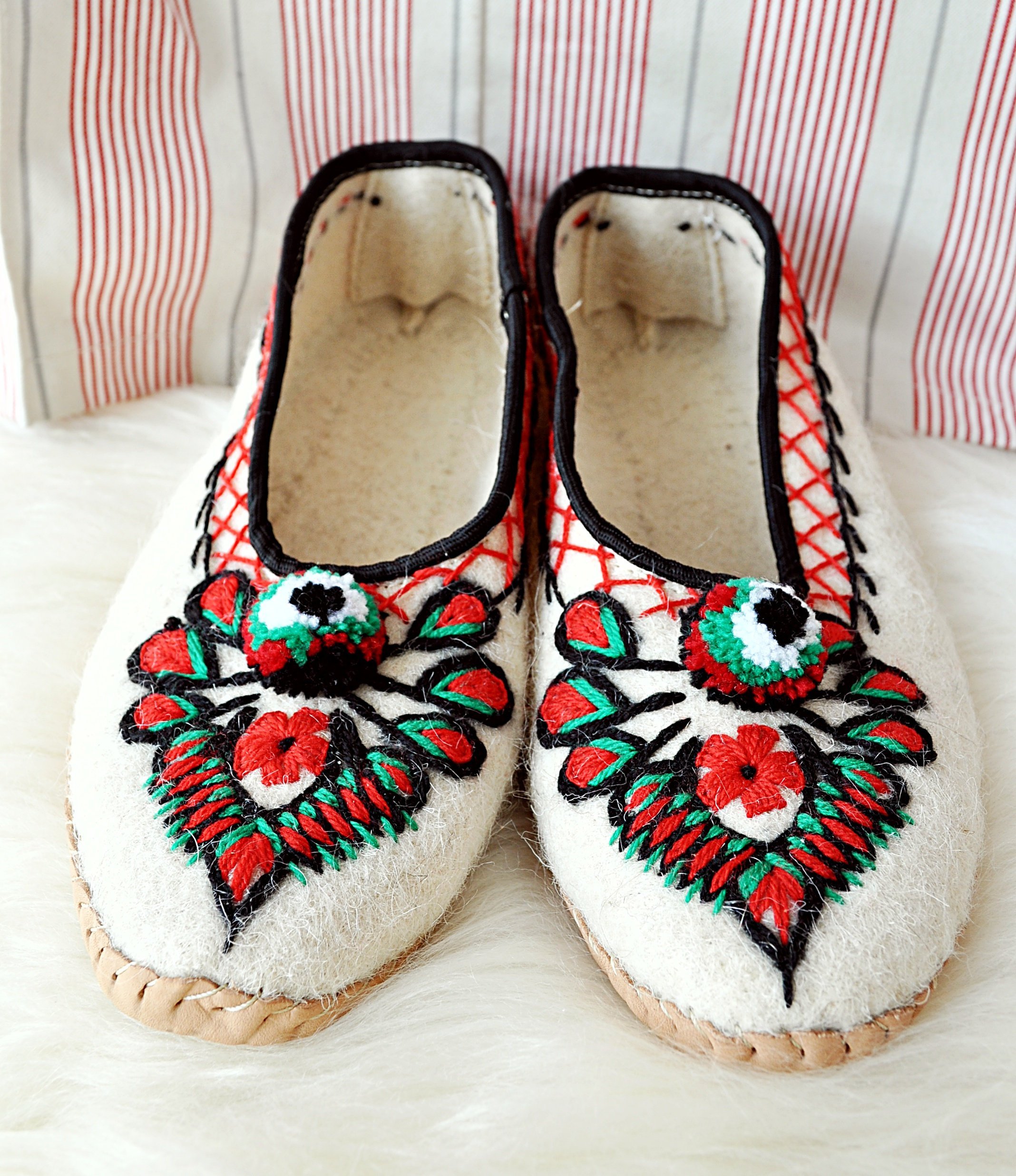 Ivory felt and real leather folk slippers, showcasing their elegant design and handmade craftsmanship.