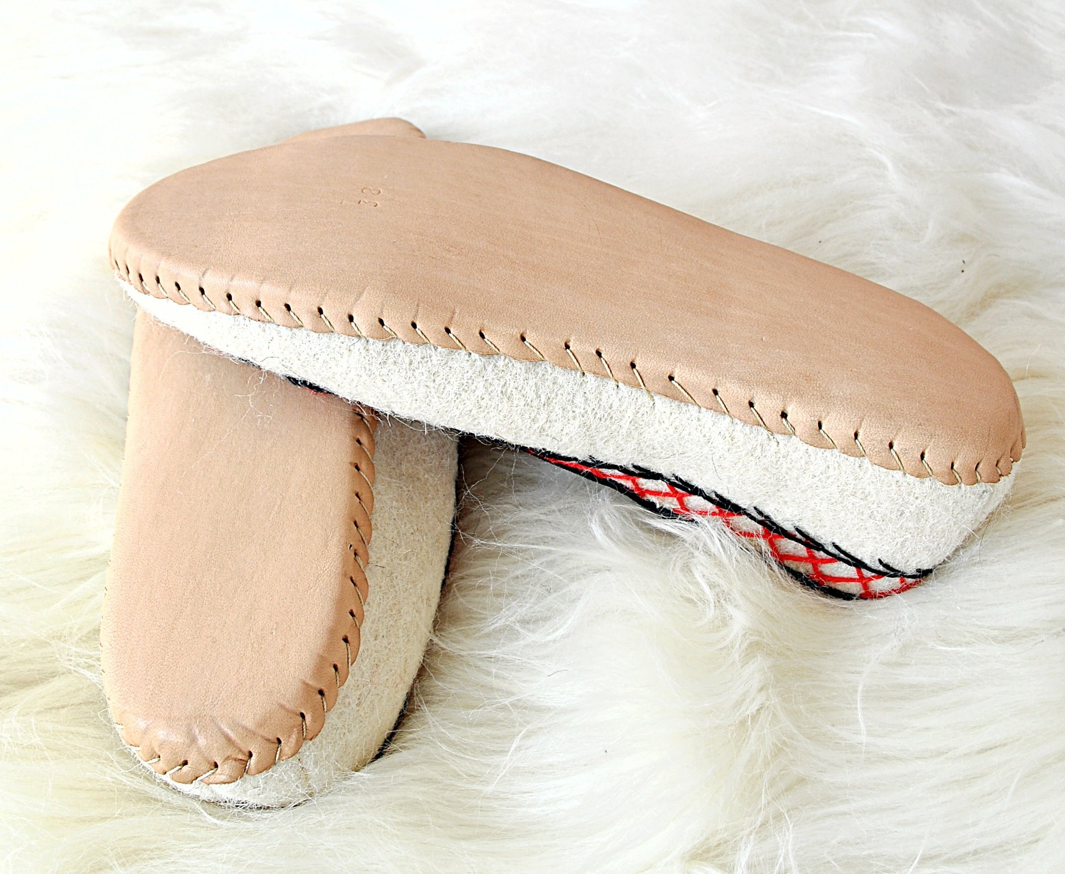 Ivory felt and real leather folk slippers, showcasing their elegant design and handmade craftsmanship.