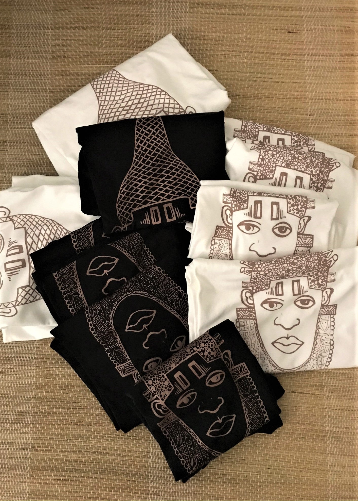IYOBA Art Tee featuring rose-gold and black prints on a white background, showcasing the face of Queen IDIA from Ancient Benin.