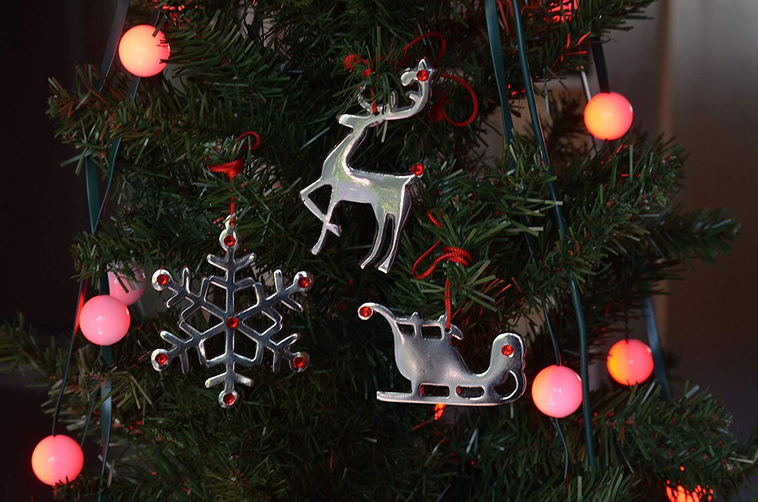 Set of 8 handcrafted Jingle Bell Christmas tree ornaments featuring a reindeer design with red ruby crystals and silver nickel finish.
