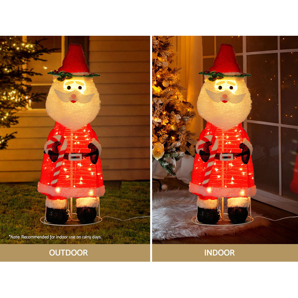 Jingle Jollys Christmas Lights featuring a 3D Santa motif, glowing warmly in a festive setting.
