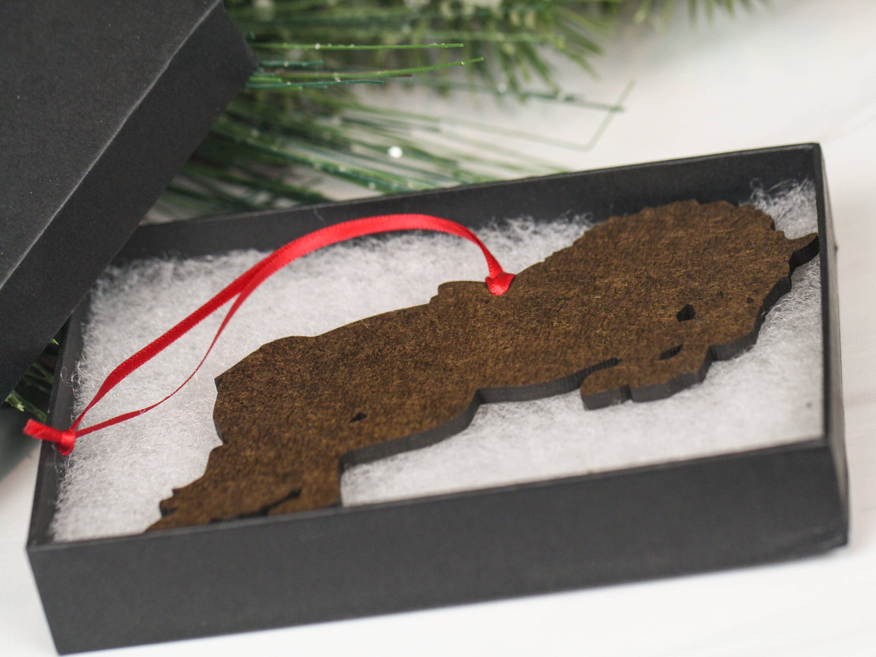 A beautifully crafted chestnut horse ornament, featuring a glossy finish and intricate laser-cut details, perfect for holiday decoration.