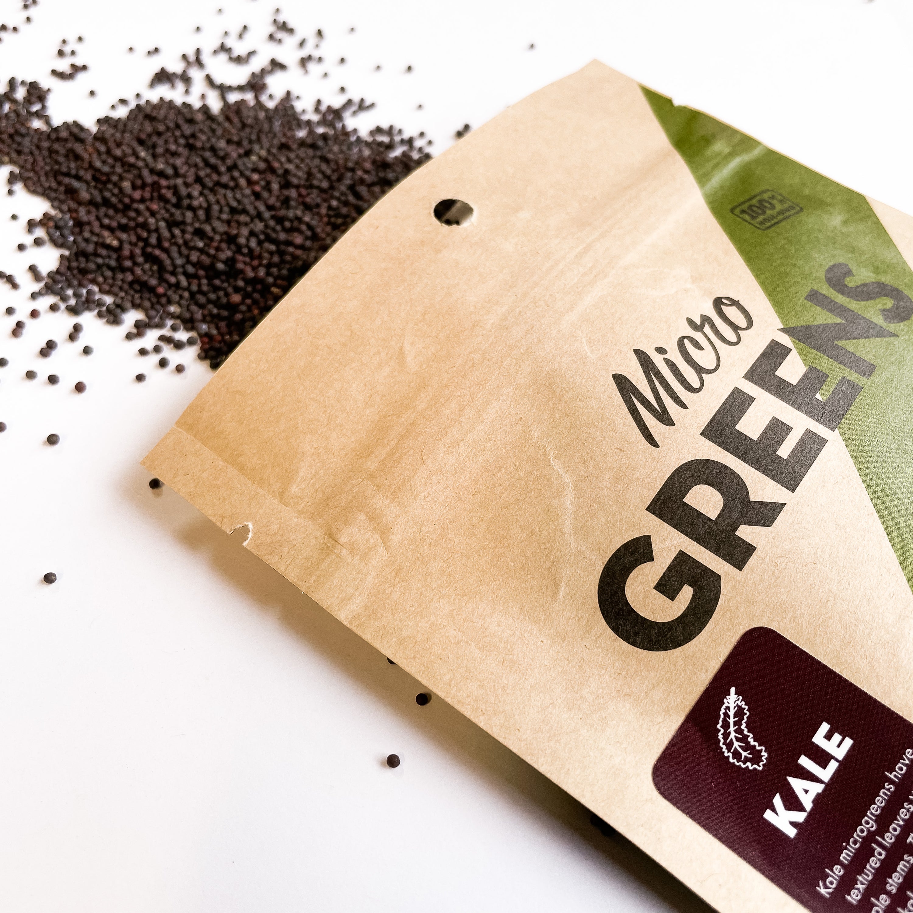 A close-up of kale microgreens growing in a tray, showcasing their vibrant green leaves and healthy growth.