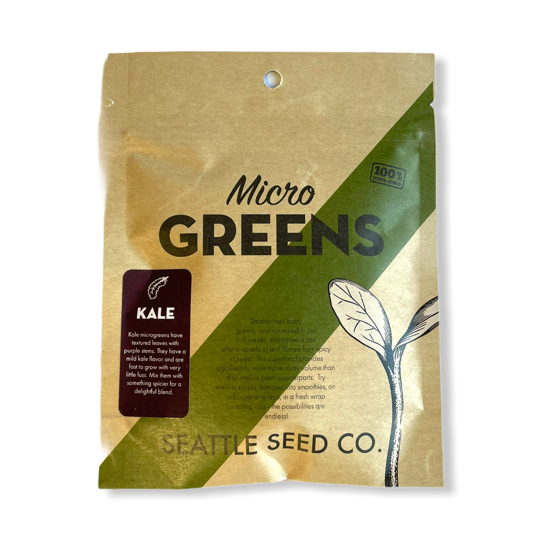 A close-up of kale microgreens growing in a tray, showcasing their vibrant green leaves and healthy growth.