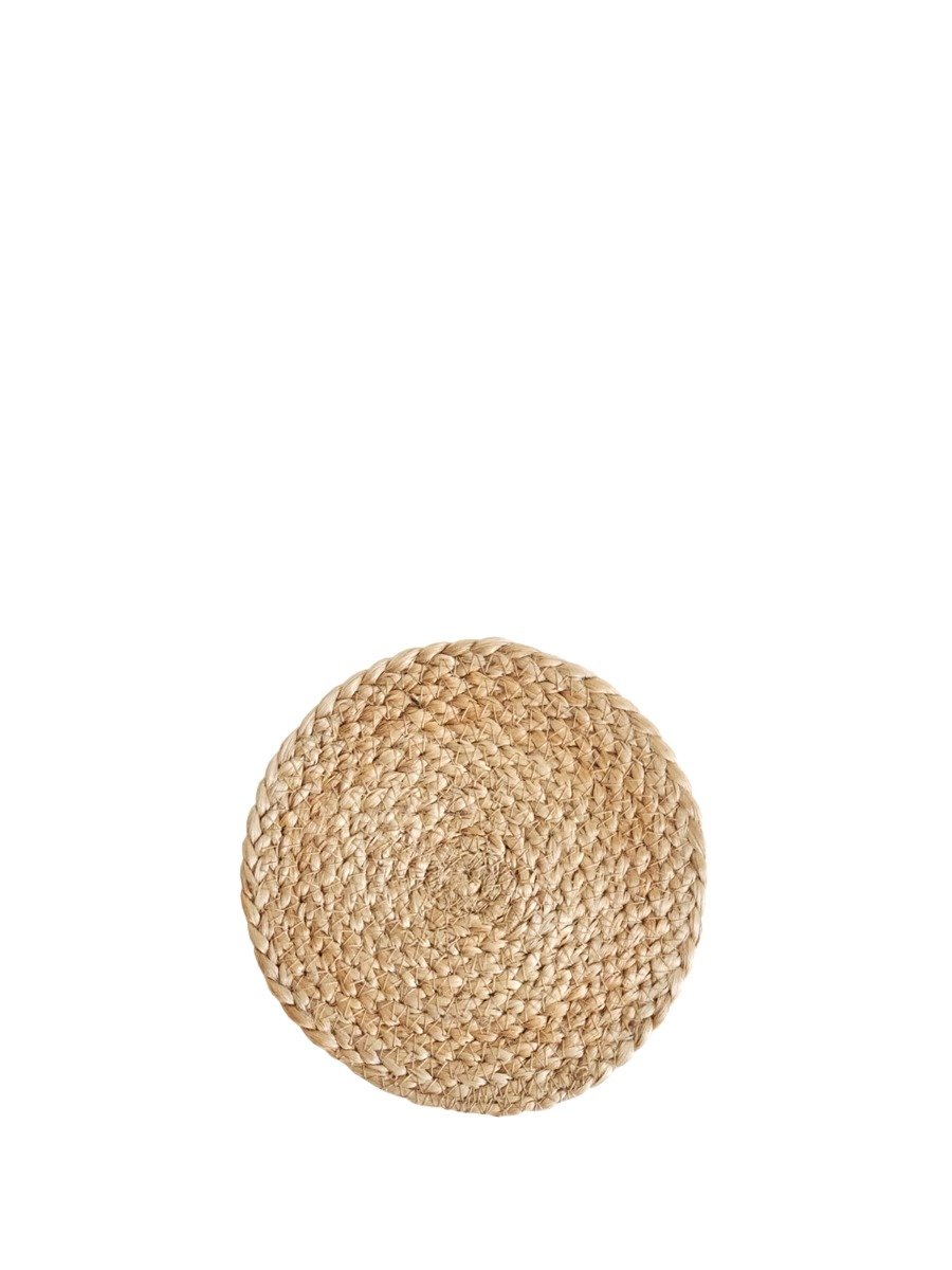 Set of four handmade jute coasters, round and natural in color, designed to protect surfaces from scratches and moisture.