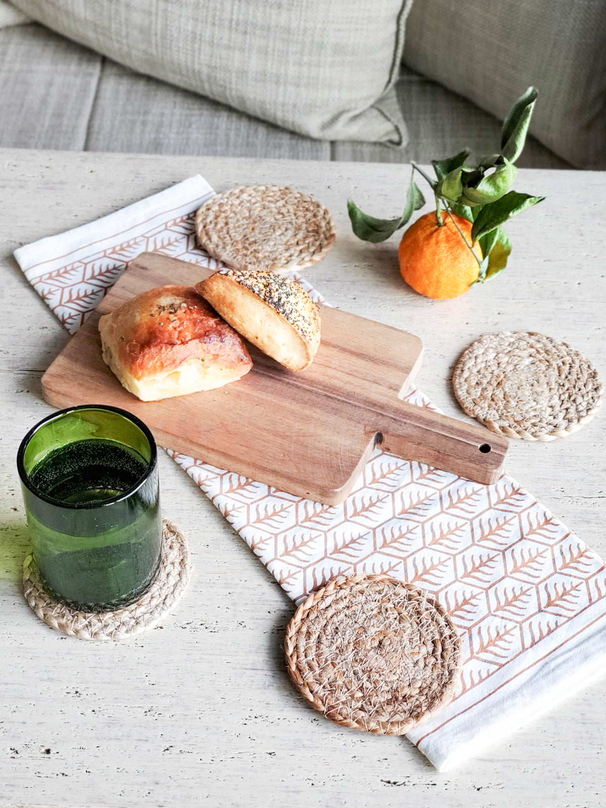 Set of 4 handmade jute drink coasters, round and natural color, perfect for protecting surfaces.
