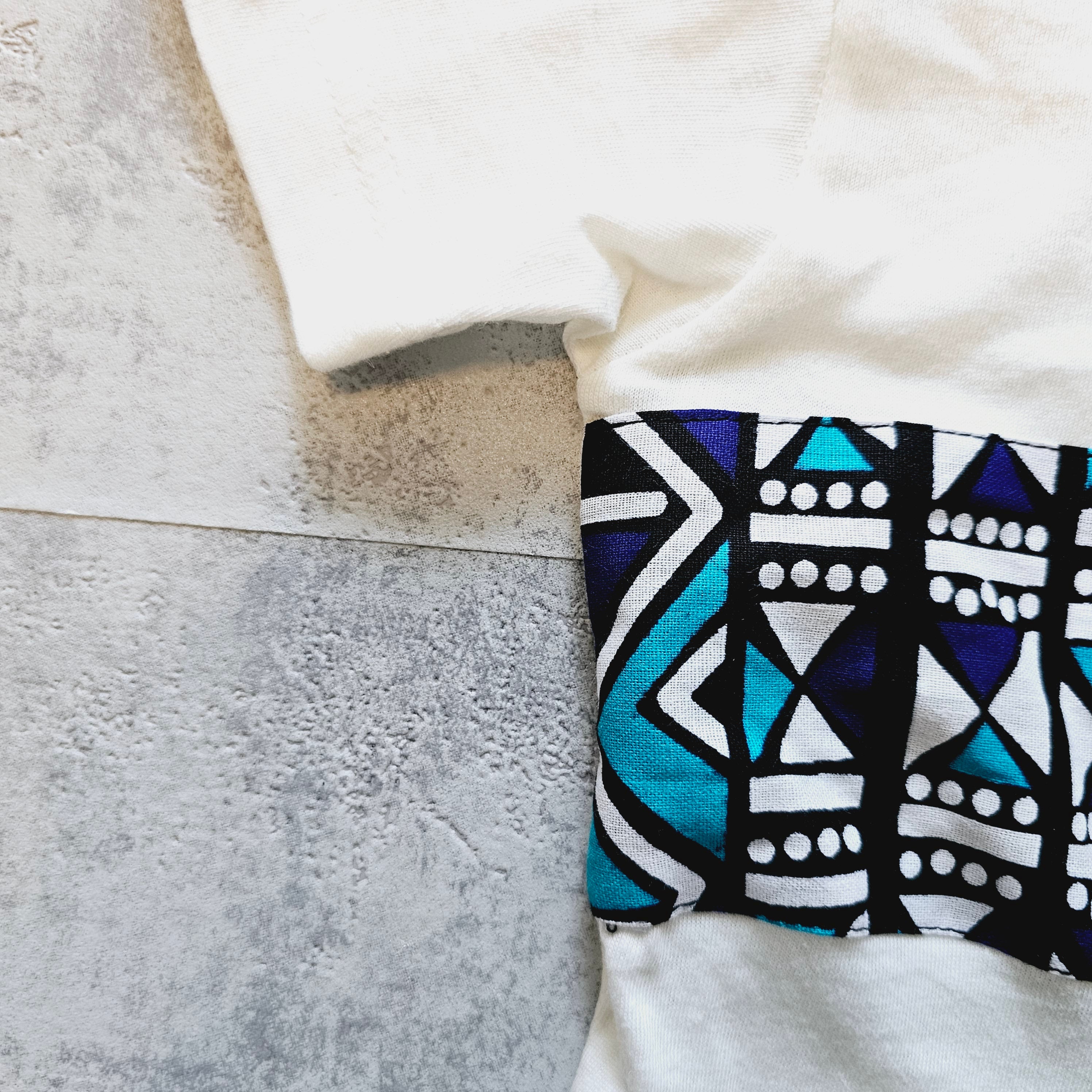 Kids T-shirt featuring vibrant African Ankara print detail on soft cotton fabric, perfect for stylish and comfortable wear.