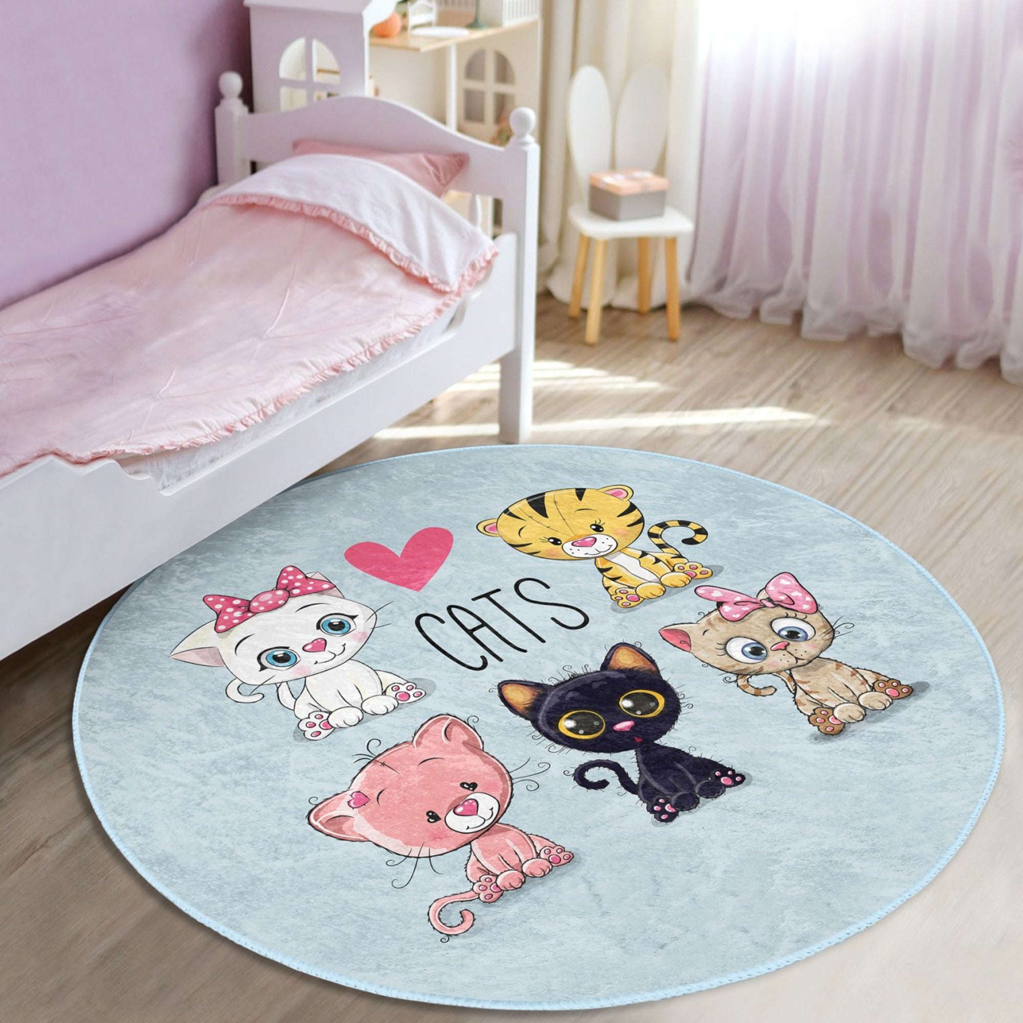 A round rug featuring a playful kitty pattern, designed for children's rooms, showcasing soft velvet fabric and vibrant colors.