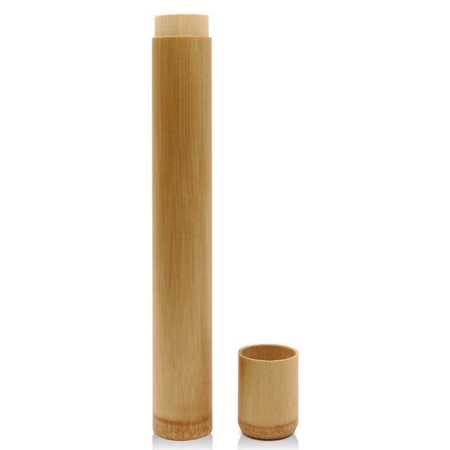 Kiwi Eco Box containing a bamboo toothbrush, bamboo case, tongue scraper, charcoal dental floss, natural toothpaste, and organic mouthwash, all plastic-free.