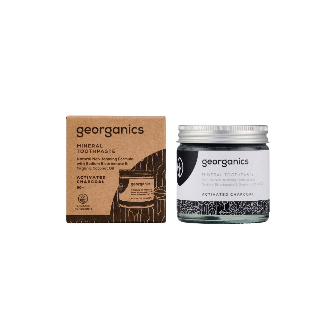 Kiwi Eco Box containing a bamboo toothbrush, bamboo case, tongue scraper, charcoal dental floss, natural toothpaste, and organic mouthwash, all plastic-free.