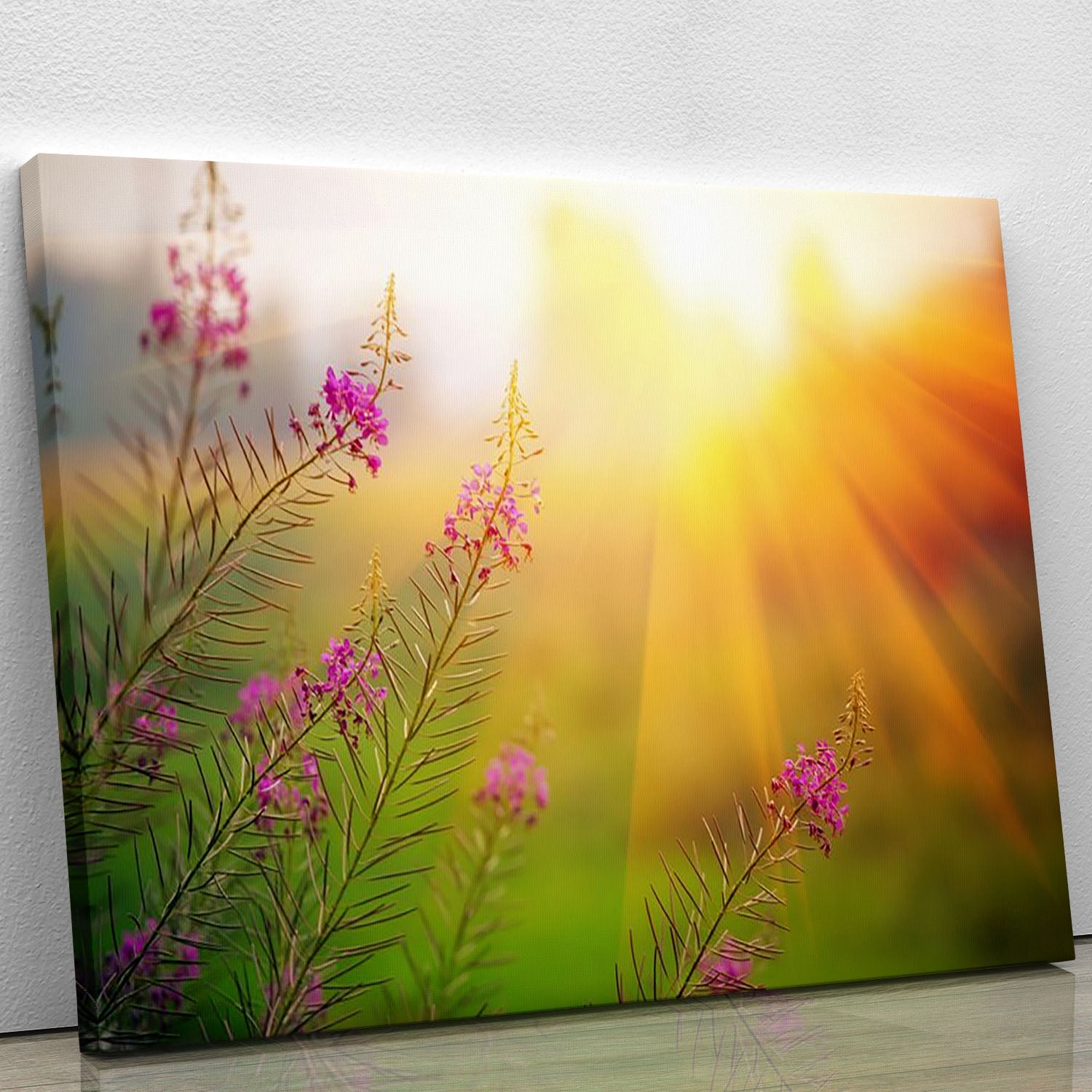 A vibrant canvas print of a landscape featuring blooming fireweed flowers under a sunny sky, perfect for home decor.