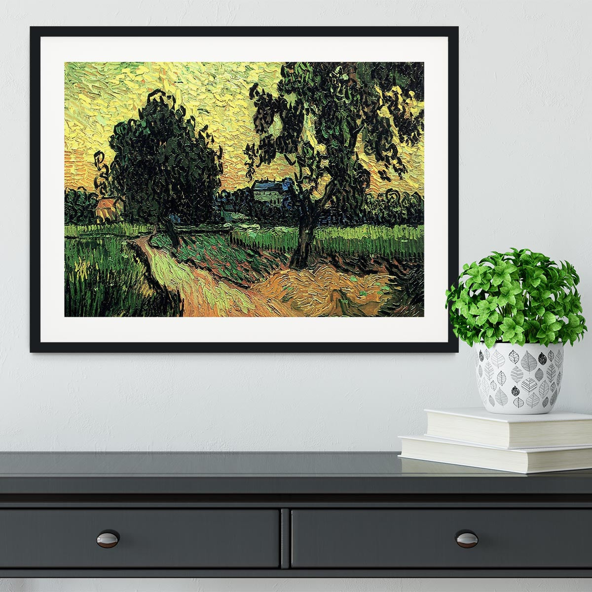Framed artwork of Van Gogh's Landscape with the Chateau of Auvers at Sunset, showcasing vibrant colors and intricate details.