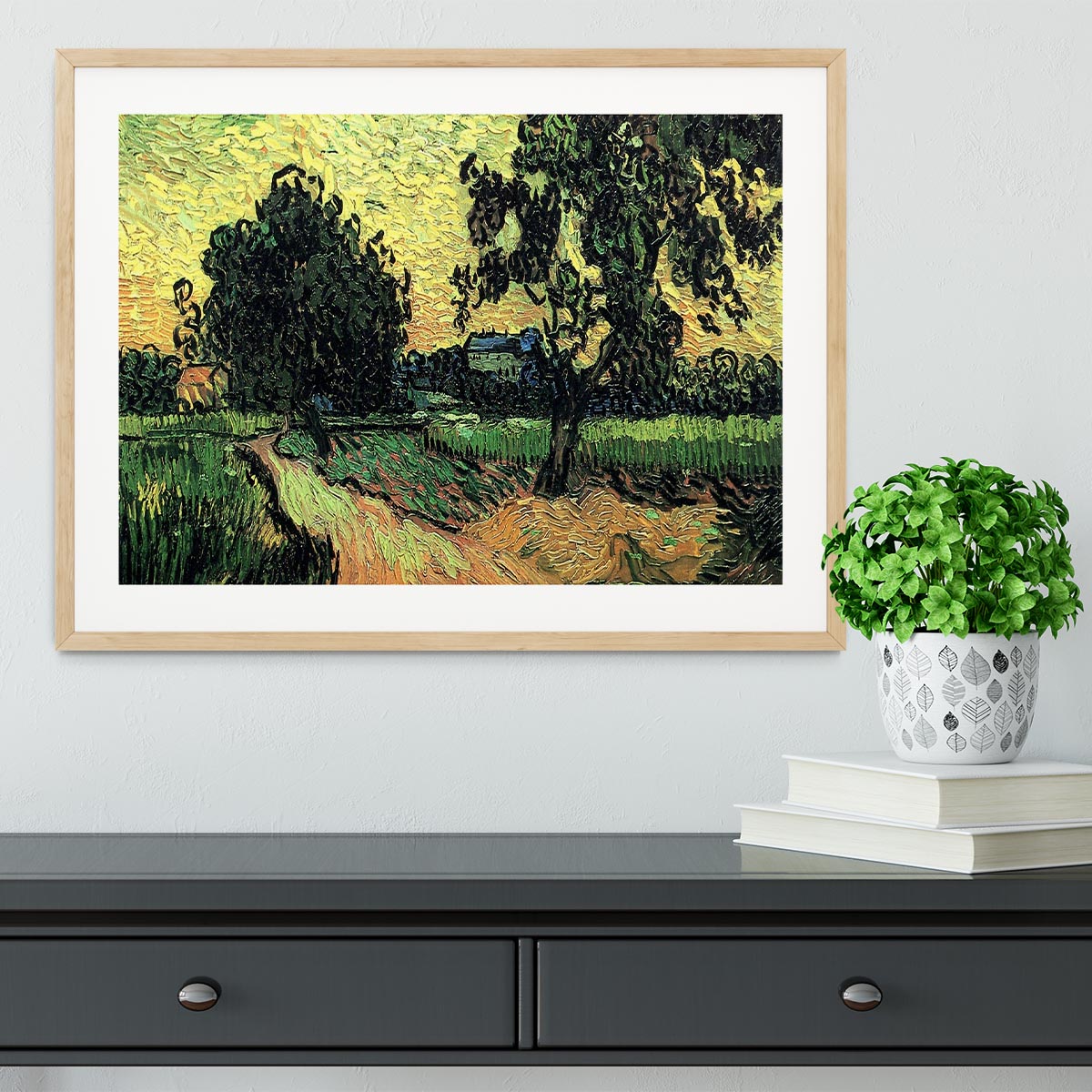 Framed artwork of Van Gogh's Landscape with the Chateau of Auvers at Sunset, showcasing vibrant colors and intricate details.
