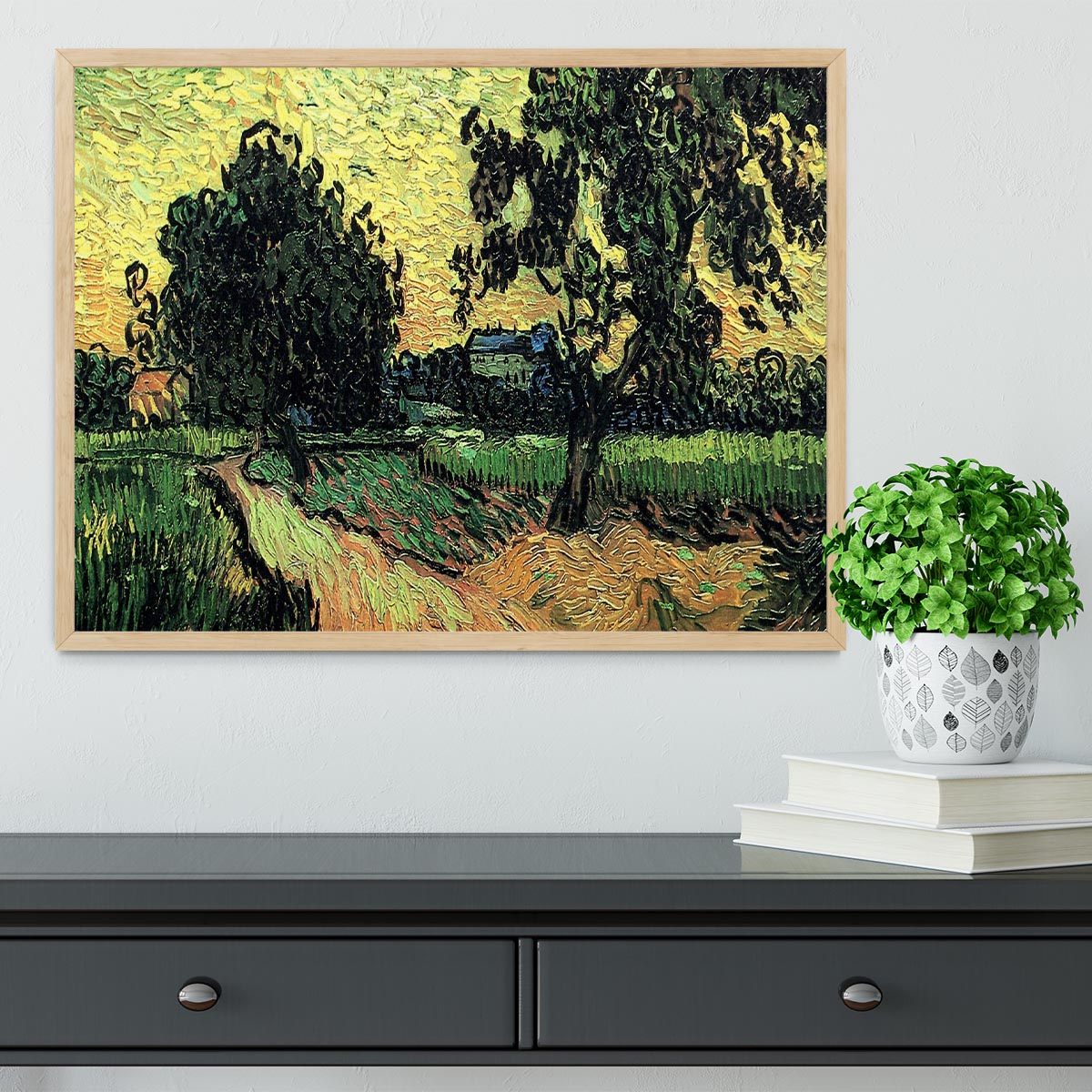 Framed artwork of Van Gogh's Landscape with the Chateau of Auvers at Sunset, showcasing vibrant colors and intricate details.