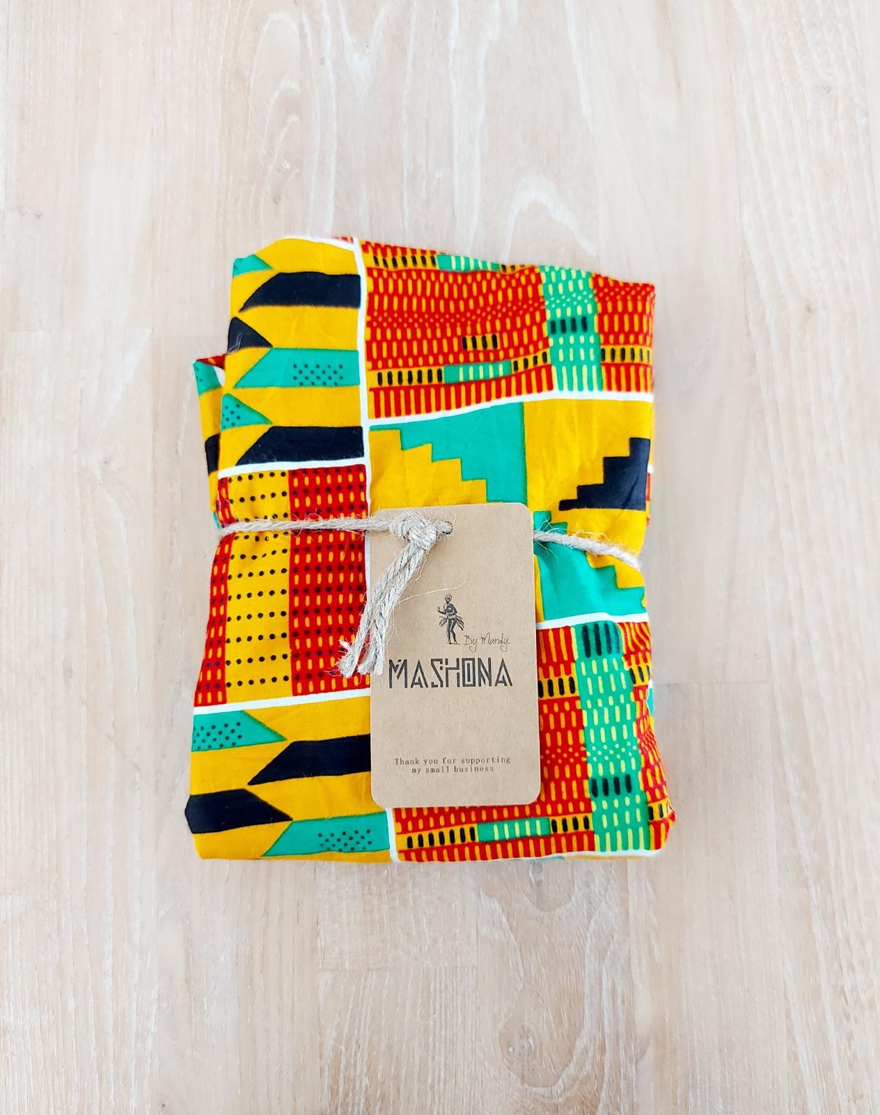 Large African Ankara print satin lined sleep bonnet cap designed for women, featuring vibrant patterns and a soft satin interior for hair protection.