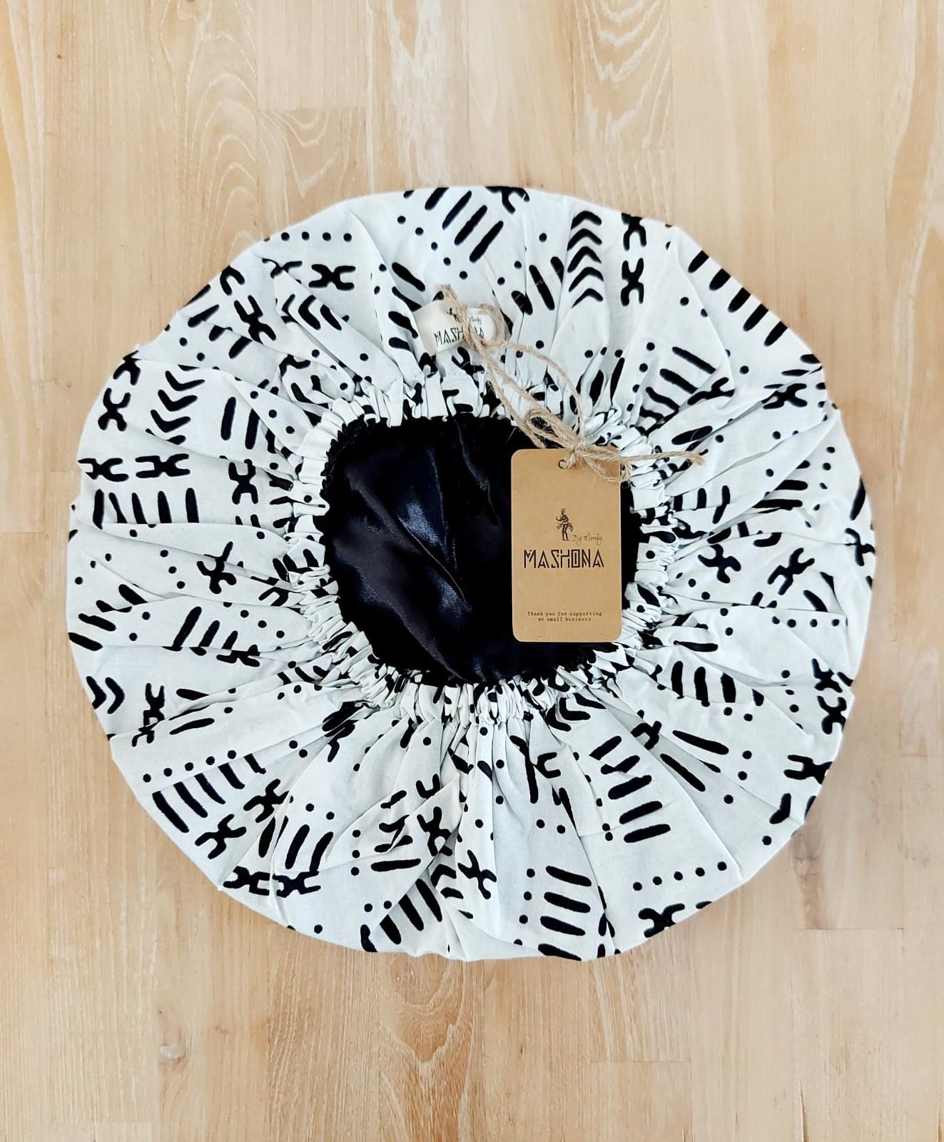 Large African Ankara print satin lined sleep bonnet cap designed for women, featuring vibrant patterns and a soft satin interior for hair protection.