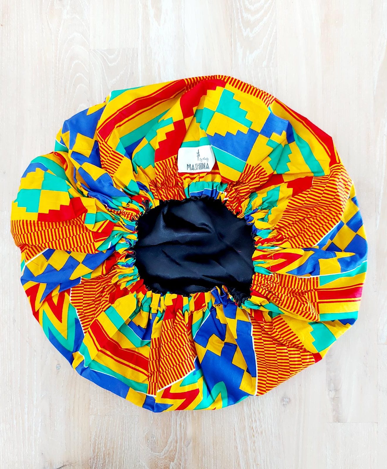 Large African Mudcloth Print Satin Lined Sleep Bonnet Cap for women, featuring a reversible design and thick elastic for a comfortable fit.