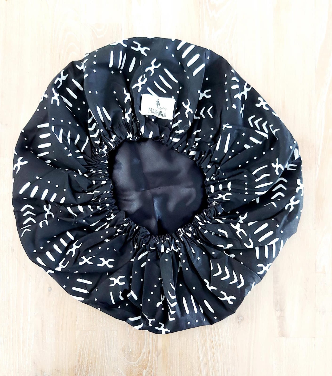 Large African Mudcloth Print Satin Lined Sleep Bonnet Cap with reversible design, showcasing vibrant patterns and soft satin lining.