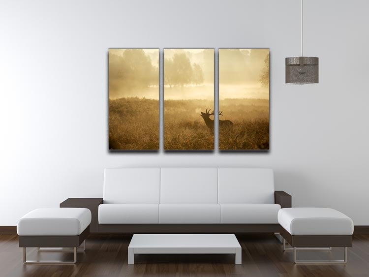 Large red deer stag silhouette in autumn, displayed on a 3-panel canvas print, showcasing vibrant colors and elegant design.