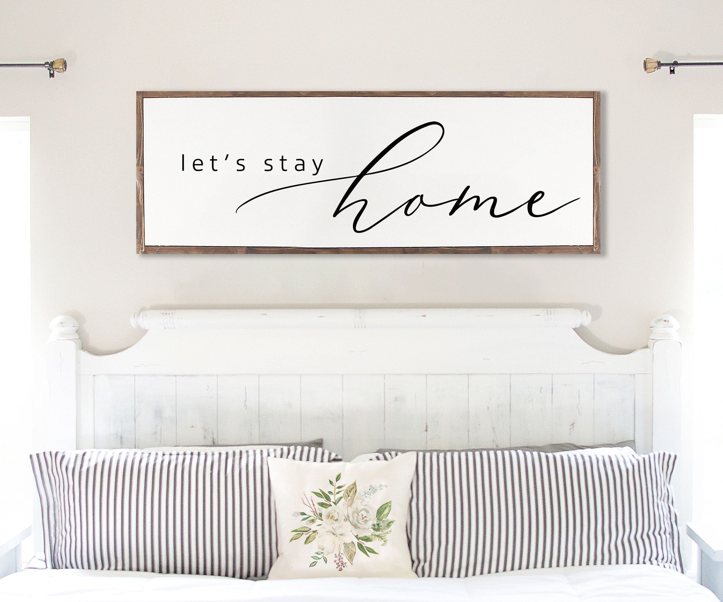 Rustic handmade wood sign featuring the phrase 'Let's Stay Home', framed and stained in customizable colors, showcasing unique wood grain.