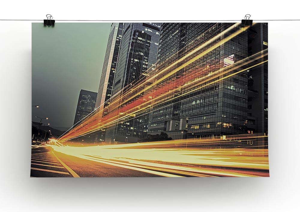 A vibrant canvas print featuring light trails around a modern building, showcasing dynamic urban architecture.