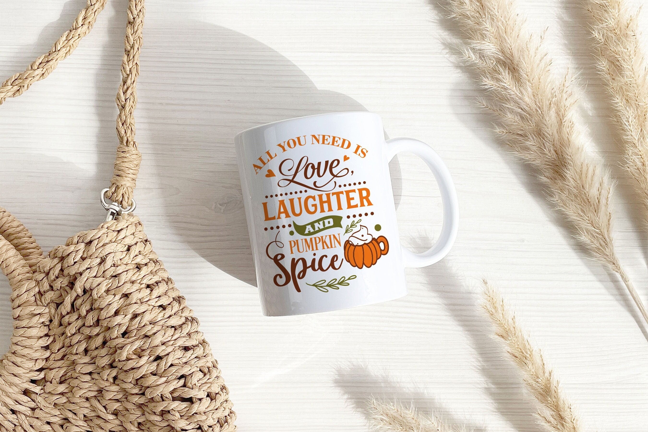 A cozy autumn-themed mug featuring the phrase 'Love Laughter and Pumpkin Spice', perfect for seasonal drinks.