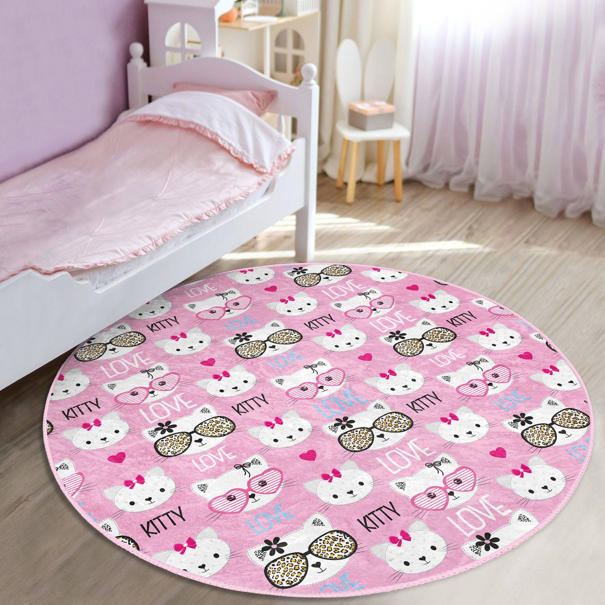 Lovely pink round rug featuring a playful kitty pattern, perfect for kids' rooms, made from soft velvet fabric.