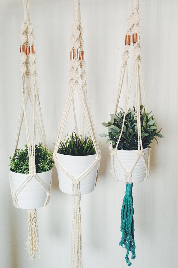 A beautifully crafted handmade macrame plant hanger made from natural cotton rope, showcasing intricate knots and a stylish design, perfect for indoor plants.