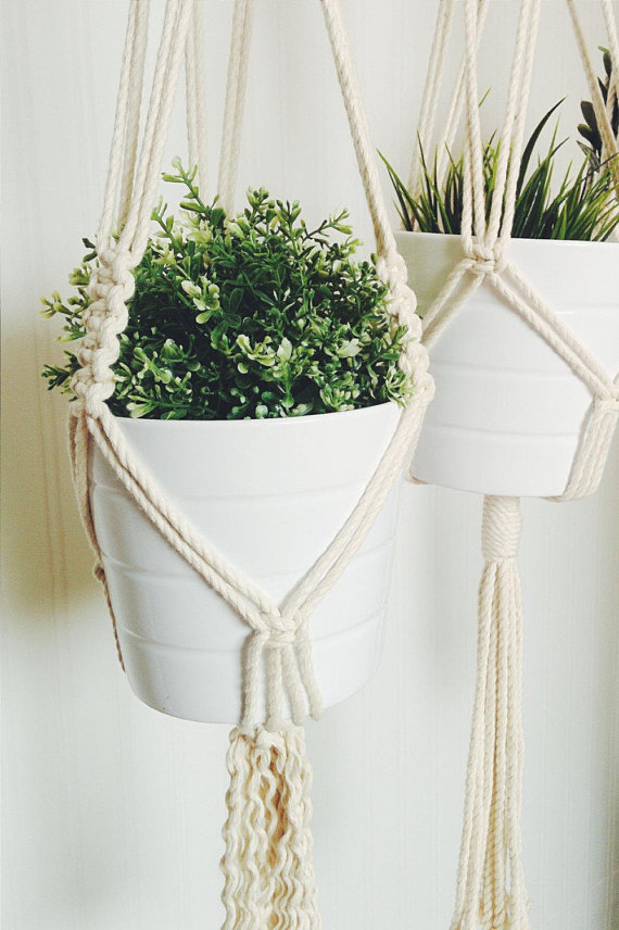 A beautifully crafted handmade macrame plant hanger made from natural cotton rope, showcasing intricate knots and a stylish design, perfect for indoor plants.
