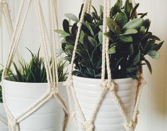 A beautifully crafted handmade macrame plant hanger made from natural cotton rope, showcasing intricate knots and a stylish design, perfect for indoor plants.