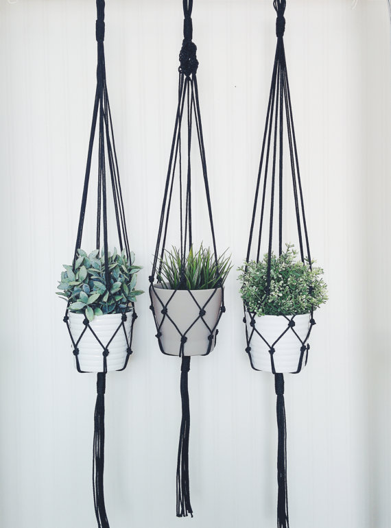 A stylish macrame plant hanger made from durable nylon cord, featuring intricate knots and a vintage-inspired design, perfect for indoor plant display.