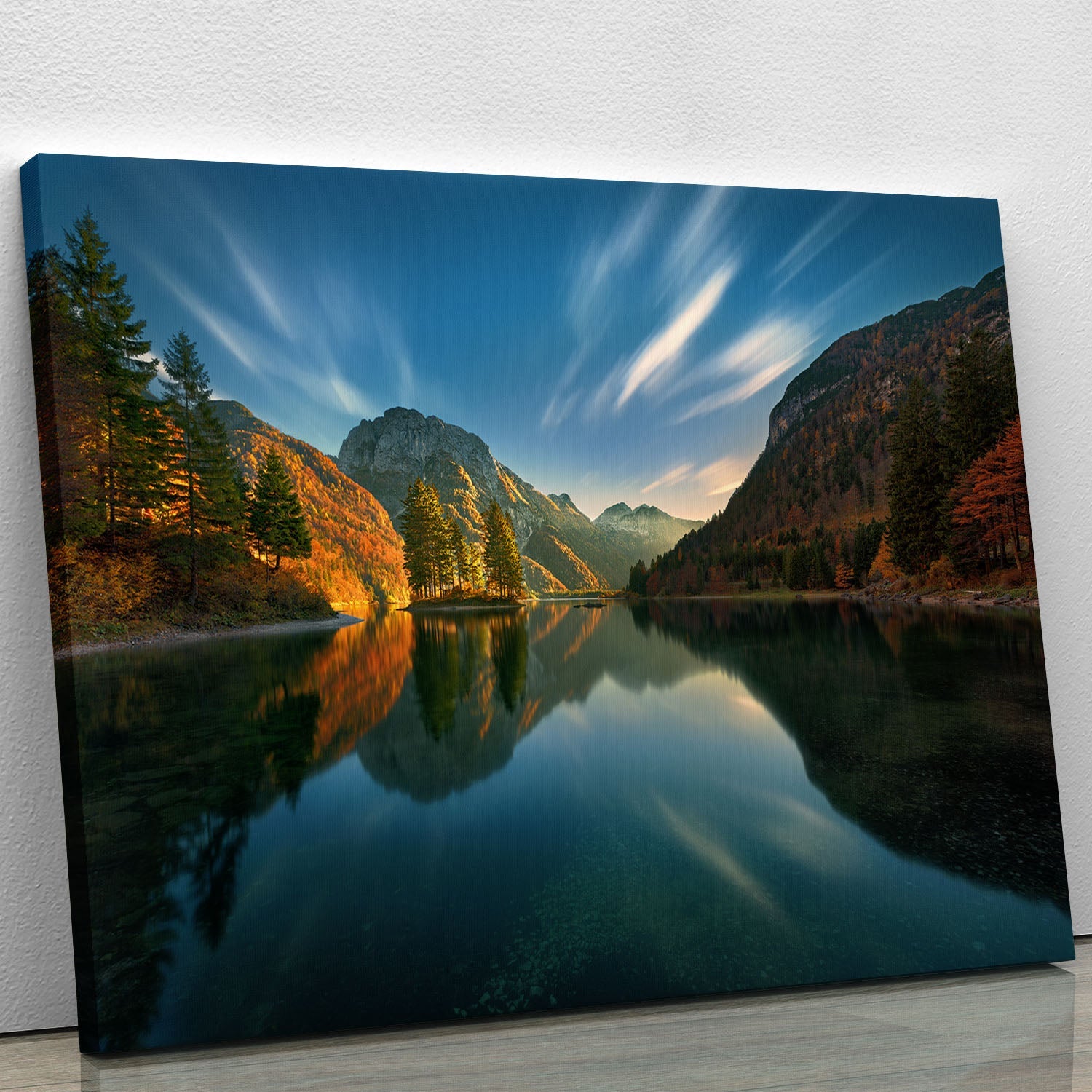 A beautiful canvas print of a tranquil lake surrounded by lush greenery and a vibrant sky, perfect for home decor.