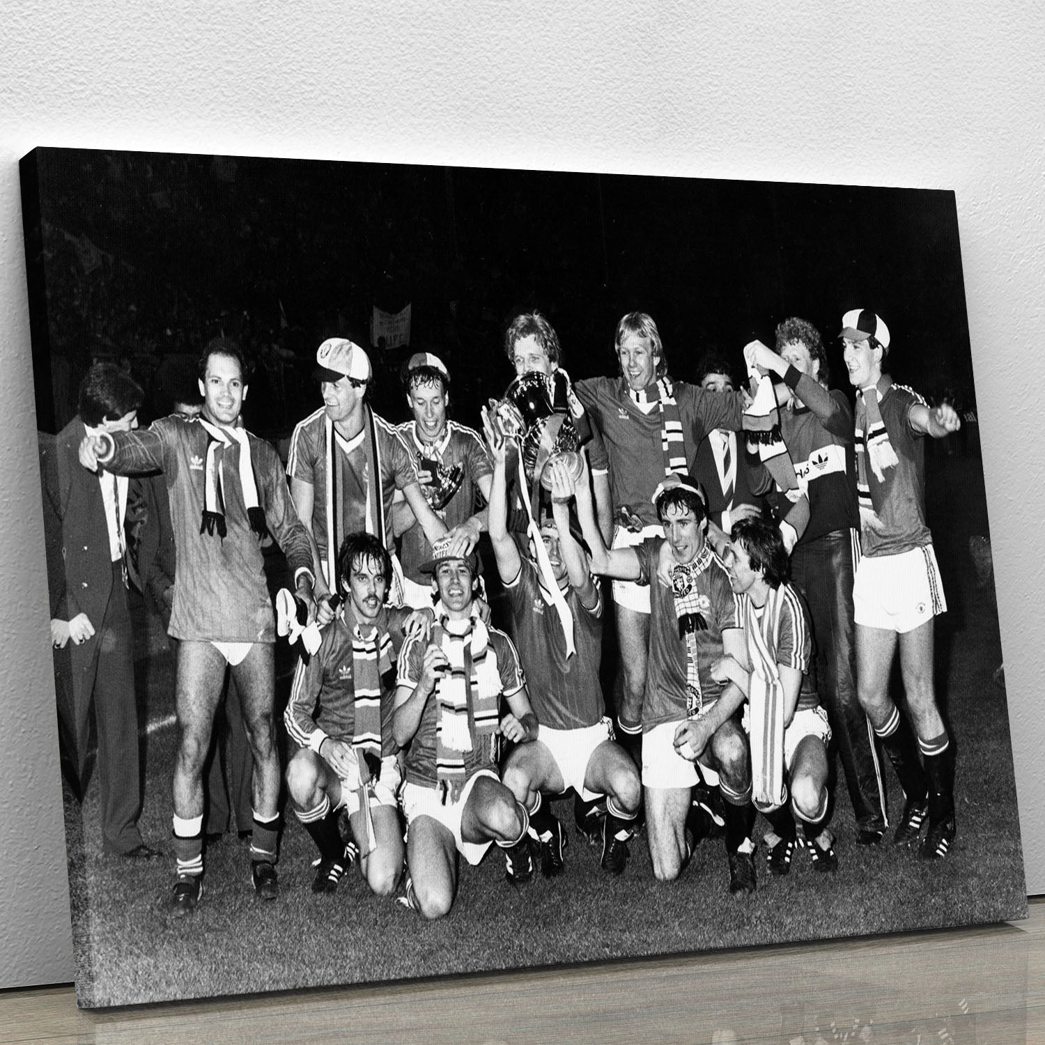 Canvas print featuring Manchester Utd players celebrating FA Cup 1983 victory, showcasing vibrant colors and detailed imagery.