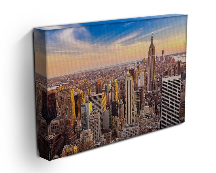 A beautiful canvas print of the Manhattan skyline at sunset, showcasing vibrant colors and iconic buildings.