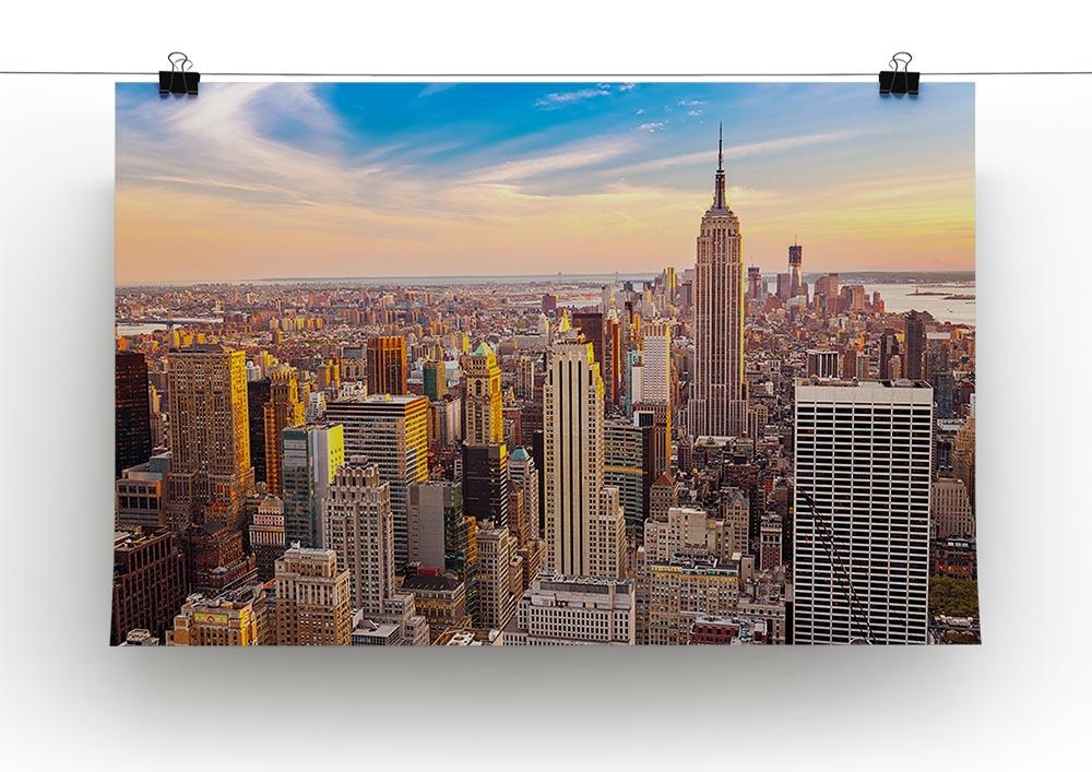 A beautiful canvas print of the Manhattan skyline at sunset, showcasing vibrant colors and iconic buildings.