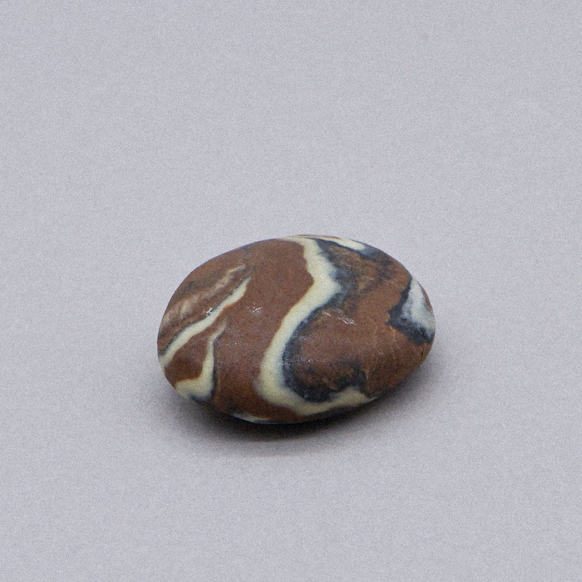 A collection of unique Marble Effect Pebble Soaps in various colors and designs, showcasing their natural and handmade quality.