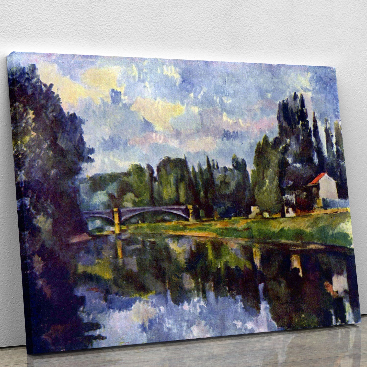 Marne Shore by Cezanne canvas print showcasing a serene riverside scene with lush greenery and tranquil waters.
