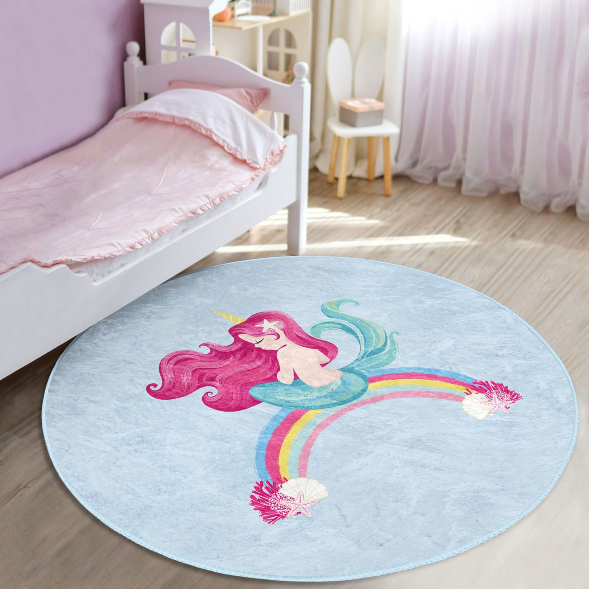 A vibrant blue kids rug featuring a whimsical mermaid design on a rainbow, perfect for children's rooms.