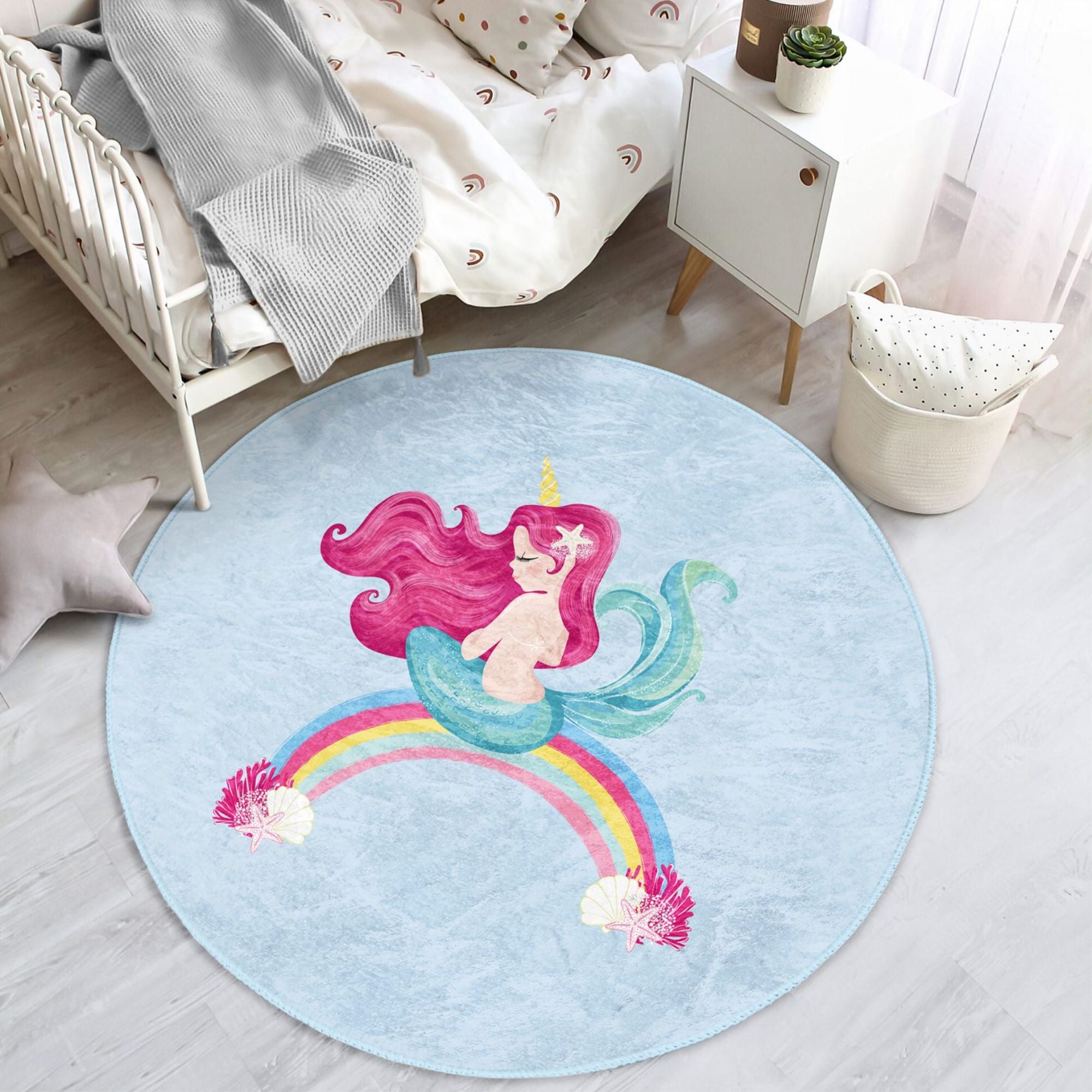 A vibrant blue kids rug featuring a whimsical mermaid design on a rainbow, perfect for children's rooms.