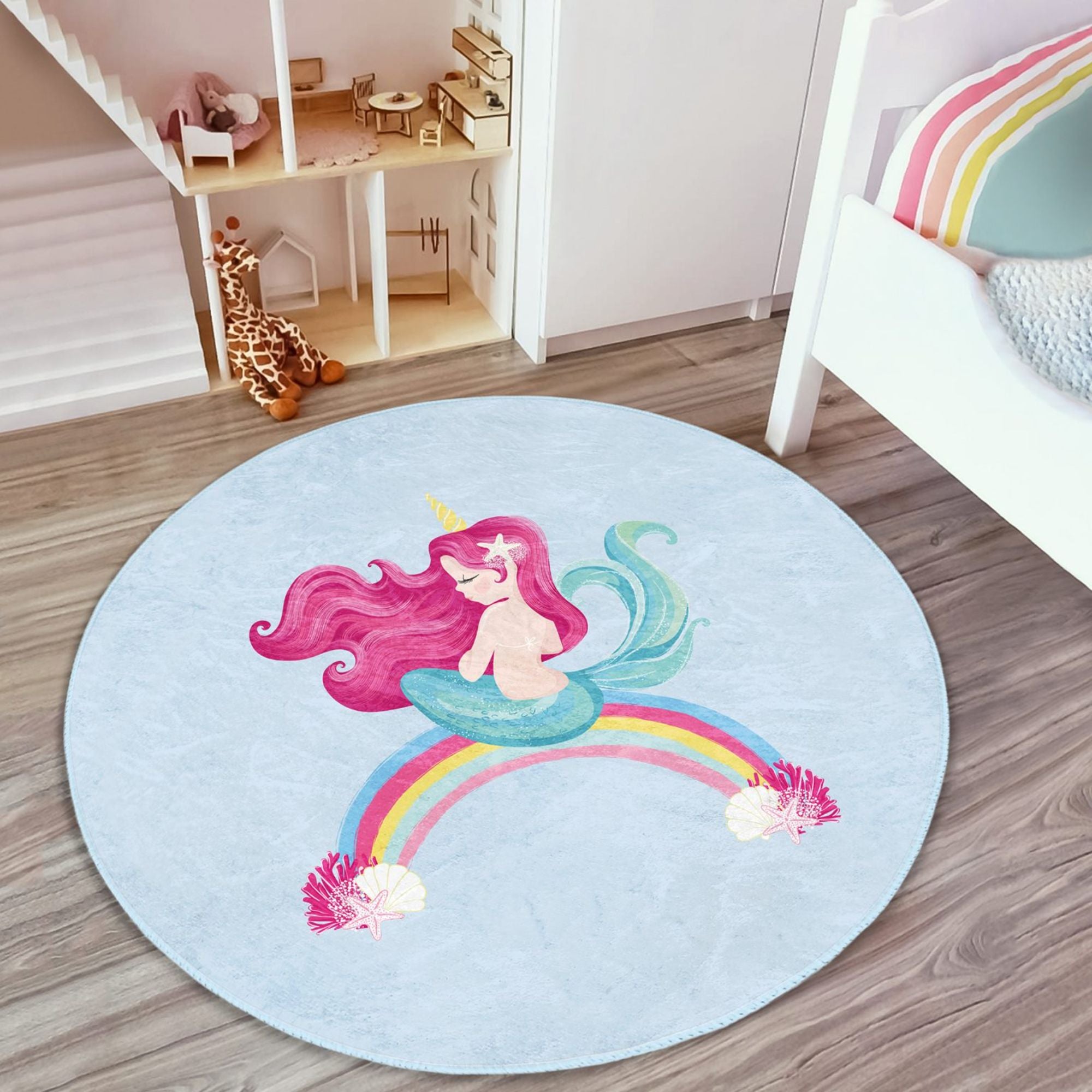 A vibrant blue kids rug featuring a whimsical mermaid design on a rainbow, perfect for children's rooms.