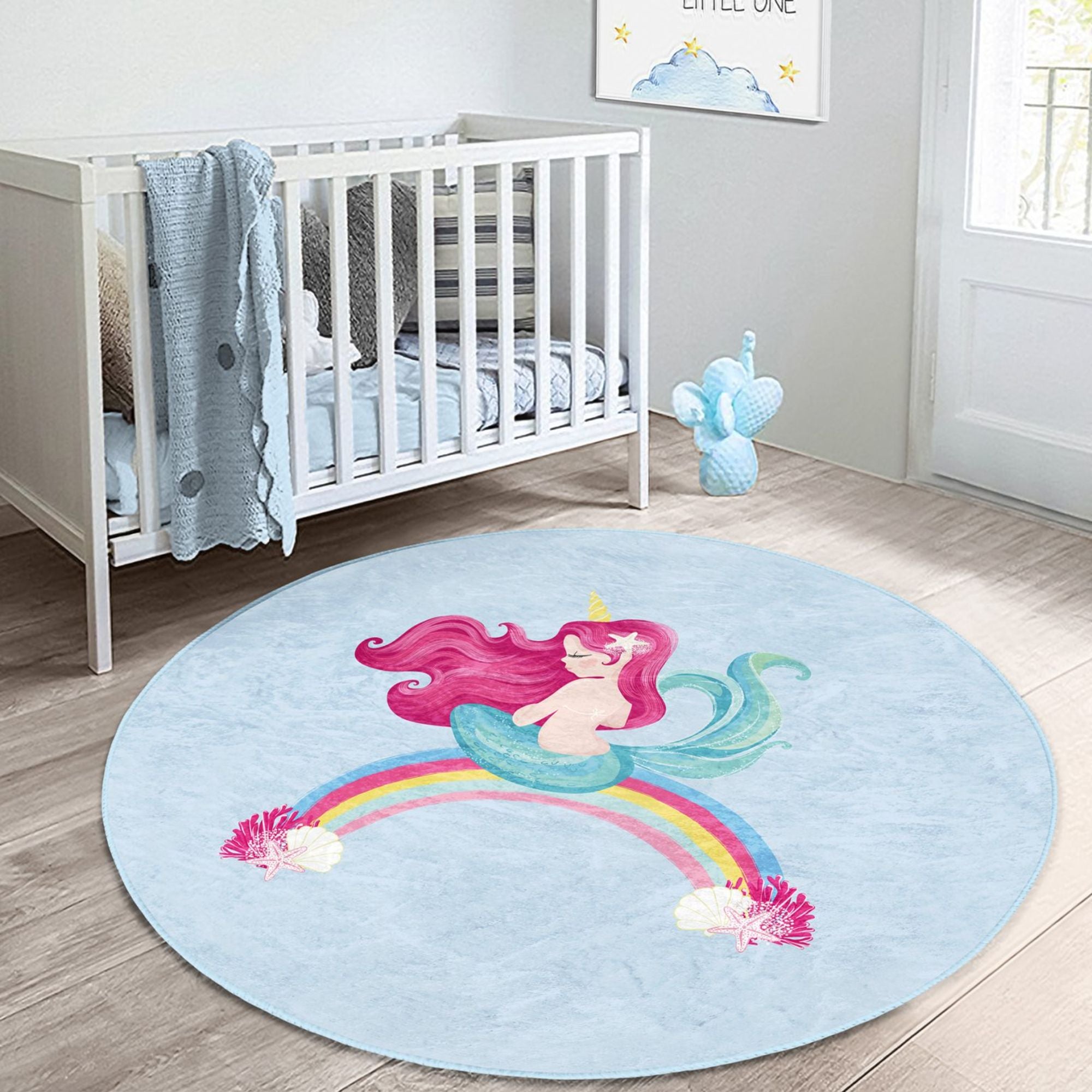 A vibrant blue kids rug featuring a whimsical mermaid design on a rainbow, perfect for children's rooms.