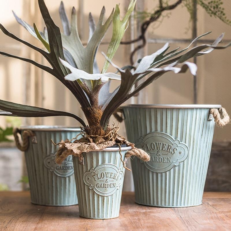 Set of three decorative metal pots with rope handles, featuring an antique paint finish in mixed green and gray colors.