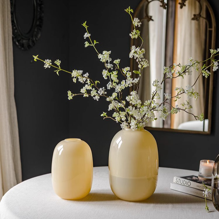 A modern hand-blown glass vase in vibrant yellow, showcasing its elegant design and perfect for floral arrangements.