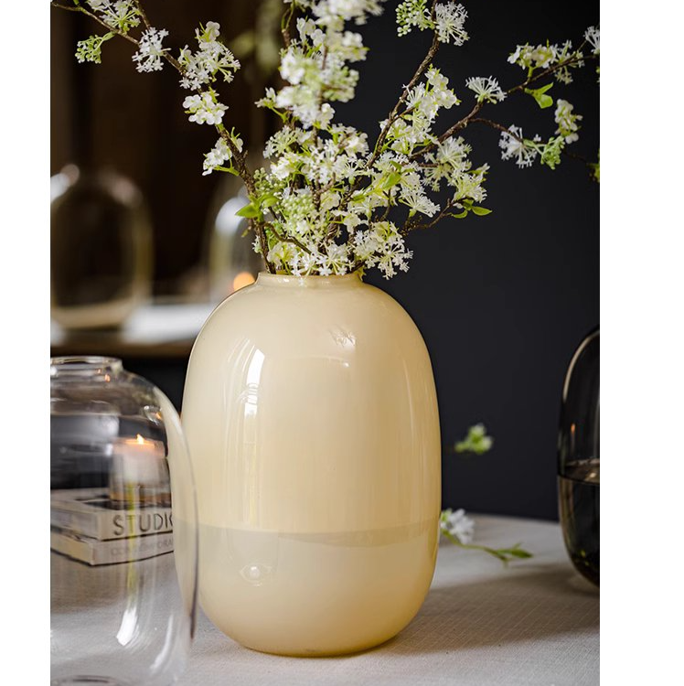 A modern hand-blown glass vase in vibrant yellow, showcasing its elegant design and perfect for floral arrangements.