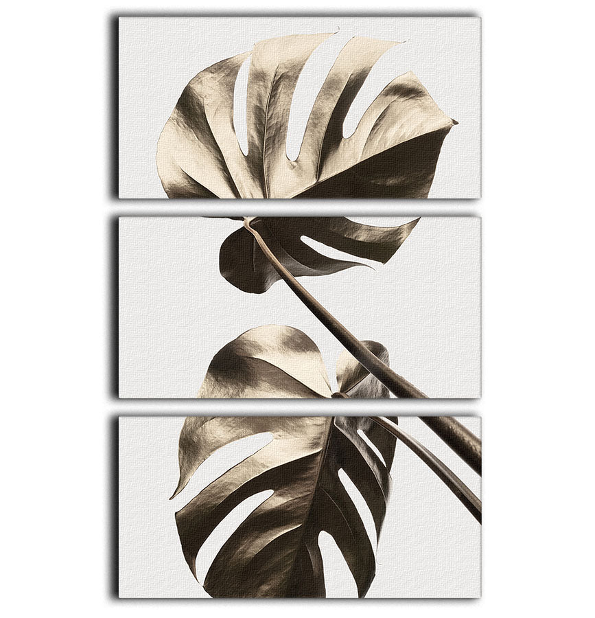 Monstera Gold 08 3 Split Panel Canvas Print featuring vibrant green monstera leaves on a gold background, elegantly displayed in three panels.